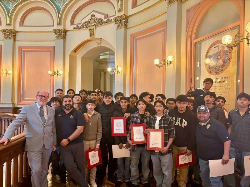 Senator Laird alongside the Everett Alvarez boys soccer team with certificates of recognition in honor of their Division I CIF Championship.