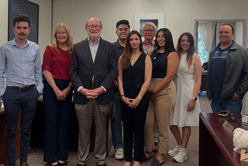 Sen. Laird standing alongside his district staff in his Santa Cruz office.