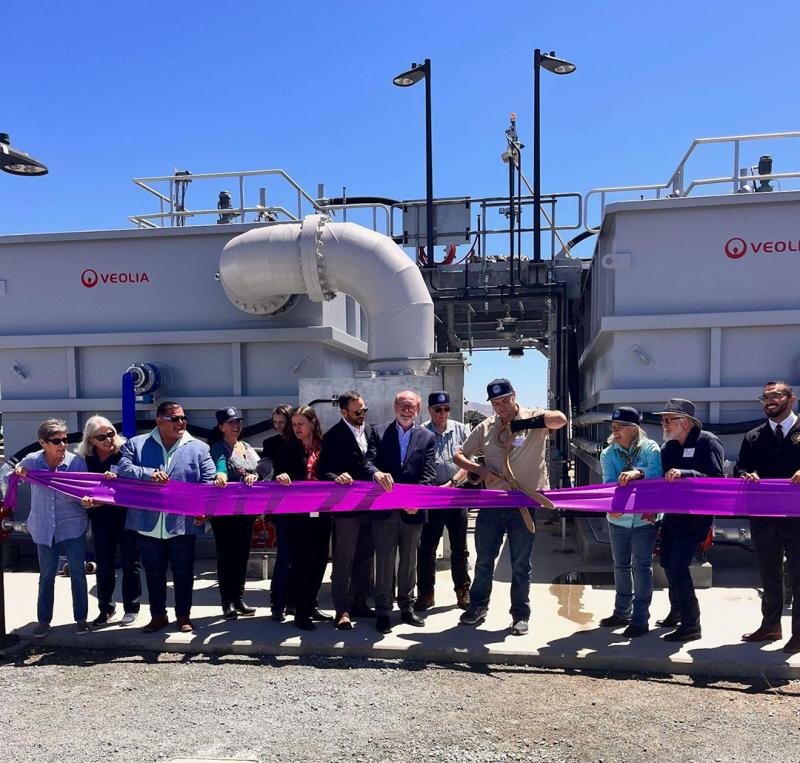 Sen. Laird standing with elected officials and Pajaro Valley Water staff cutting a giant purple ribbon