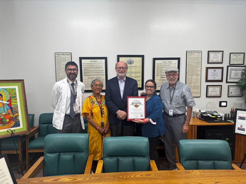 Sen. Laird standing with a Senate certificate of recognition with staff from the San Benito Health Foundation