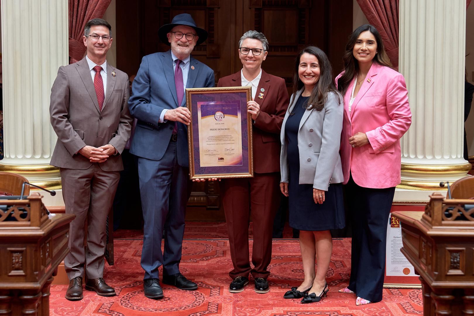 Senator Laird on the Senate Floor with the 2026 Pride Month Honoree, Pro Tem Limon, and Senator Cervantes 
